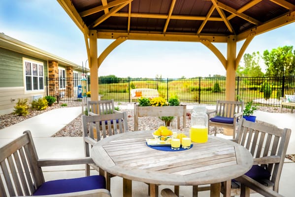 Outdoor seating area with refreshments and garden view