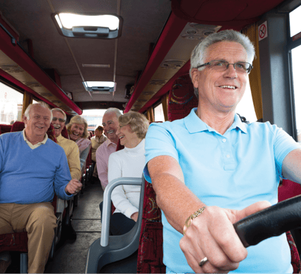 Residents enjoying a bus trip with staff assistance