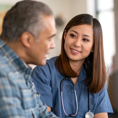 Nurse talking with a resident in a care facility