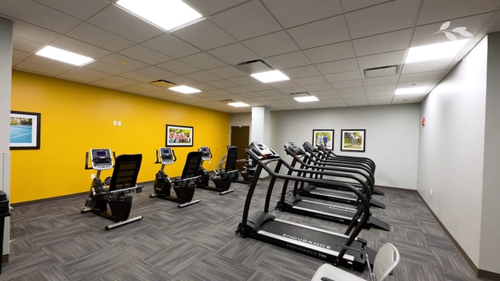 Well-equipped fitness room with exercise machines