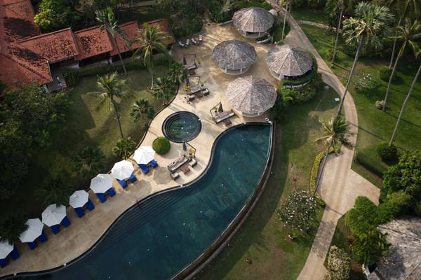 Aerial view of a pool and outdoor lounging area