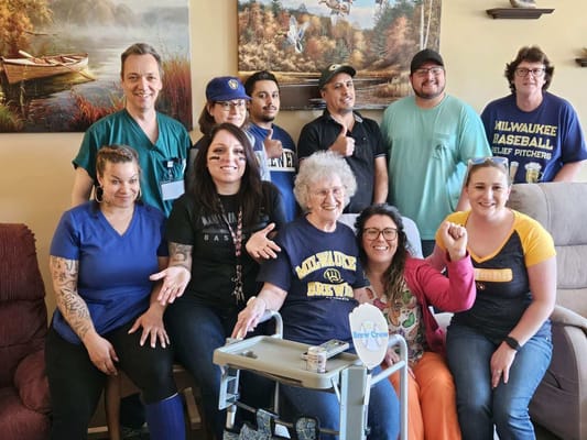 Group of staff and residents celebrating in a common area