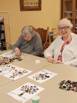 Residents engaging in a creative activity with buttons