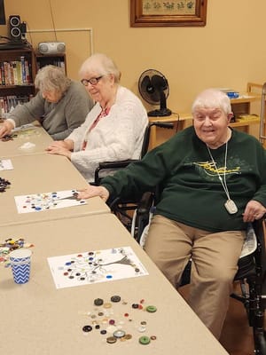Residents engaged in a creative activity at a table