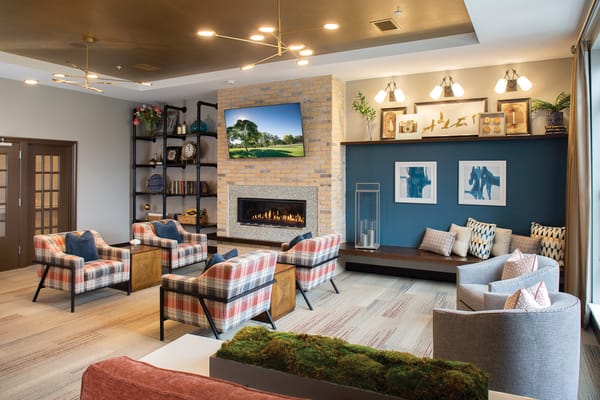 Interior view of a cozy common area with seating and fireplace