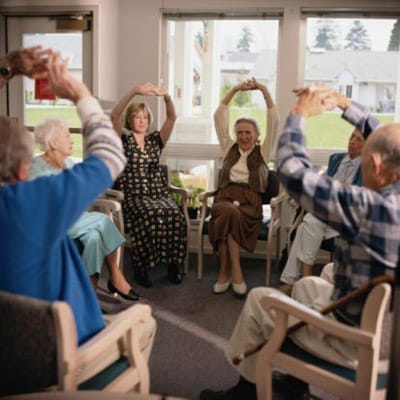 Residents participating in a seated exercise class