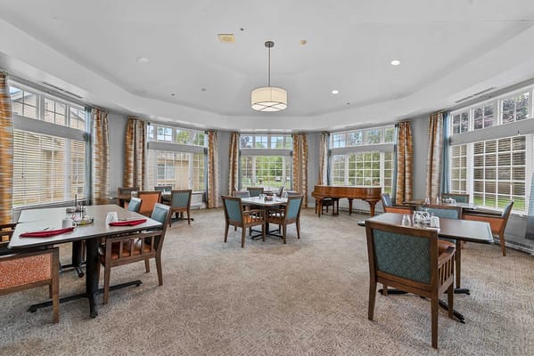 Bright dining room setup with large windows
