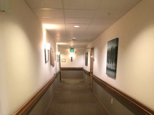 Interior hallway with soft lighting and artwork