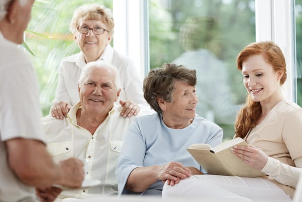 Residents and staff engaging in a warm conversation