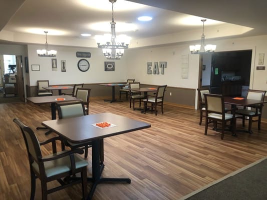 Bright dining area with tables and chairs arranged