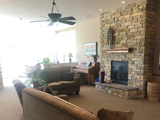 Common area with seating and a stone fireplace