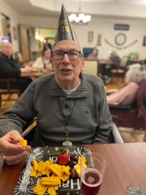 Resident celebrating New Year's with snacks and a hat