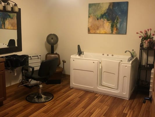 Salon area with a massage tub and styling chair