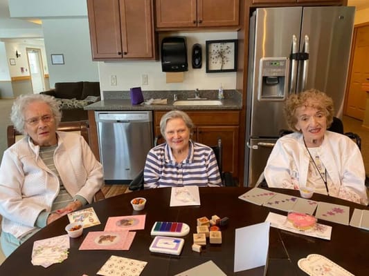 Residents engaged in a crafting activity at a table