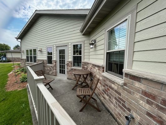 Outdoor patio area with seating and greenery