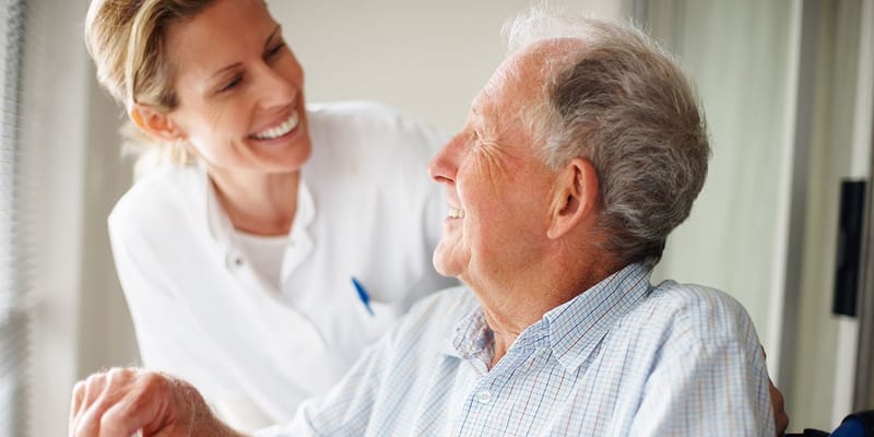 Smiling caregiver chatting with a senior resident