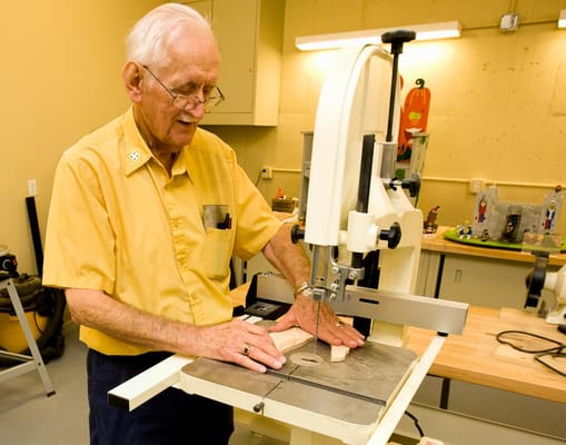 A resident using a saw in a workshop