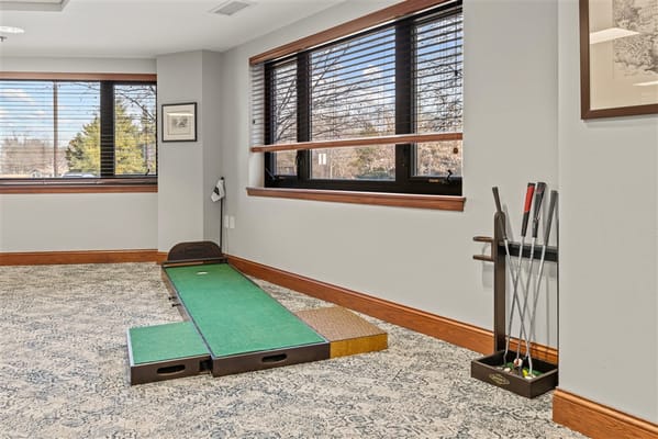 Indoor putting green with clubs in a common area