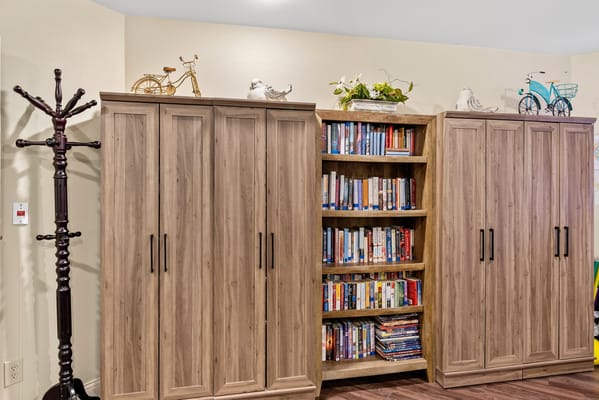 Interior view of a bookshelf and storage units in a common area