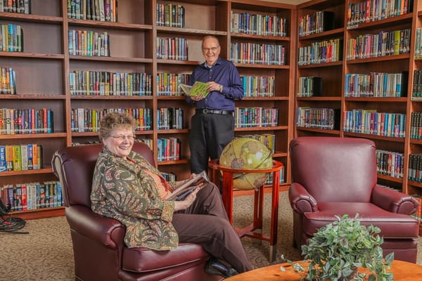 Residents enjoying time in a cozy library area