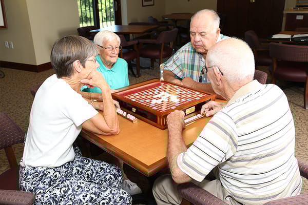 Residents engaging in a lively board game activity