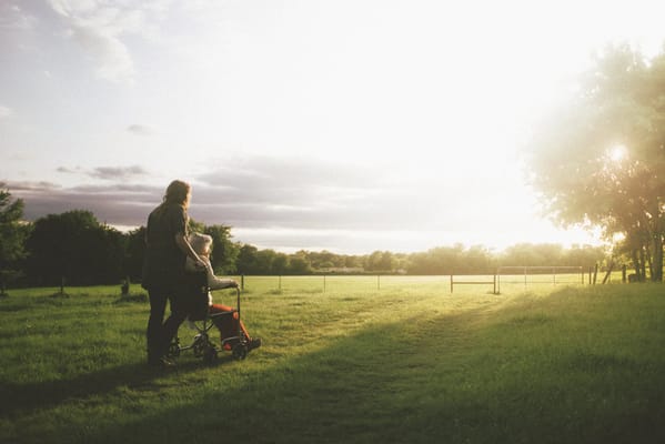A caregiver and resident in a peaceful outdoor setting