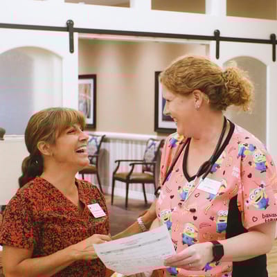 Staff members laughing while reviewing a document