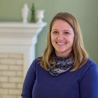 Staff member smiling in a facility interior