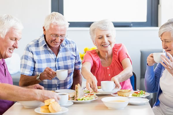 Residents enjoying a meal together in the dining room