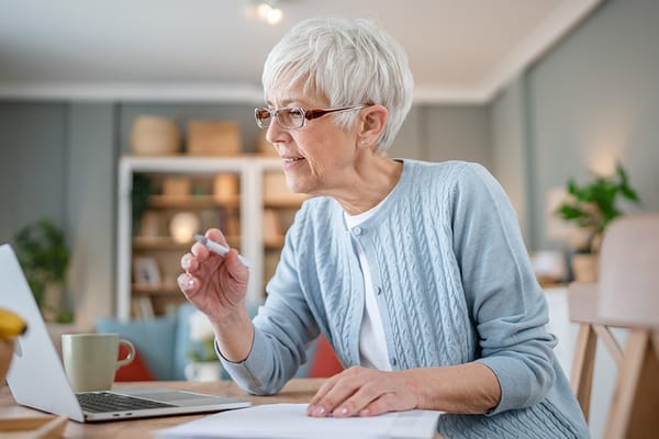 Senior woman engaging with a laptop in a cozy living area