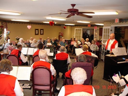 Residents enjoying a musical performance in a common area