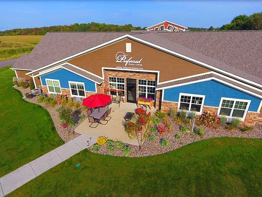 Exterior view of Preferred Senior Living with outdoor seating