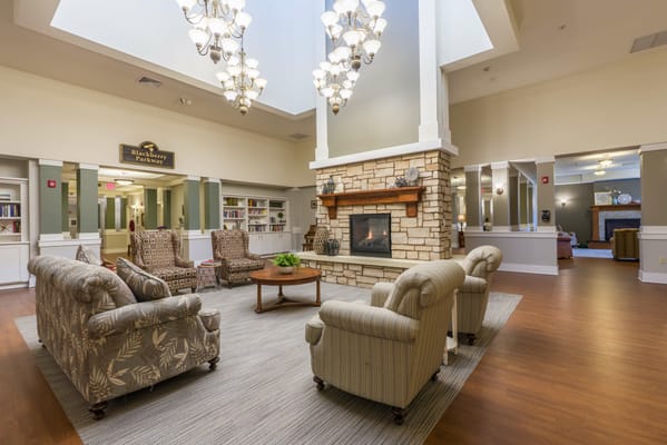 Bright and welcoming common area with seating and fireplace