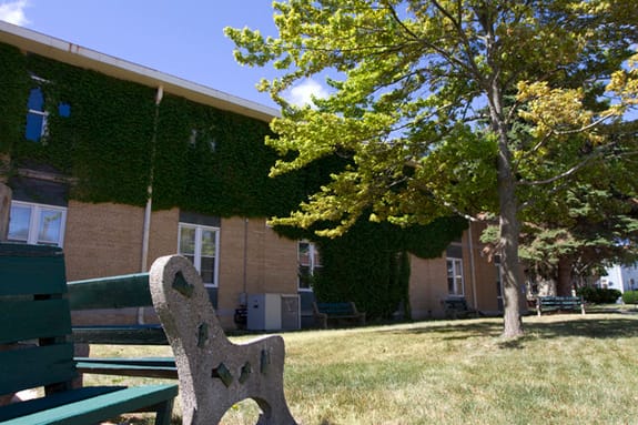 Outdoor seating area with greenery in a senior living facility