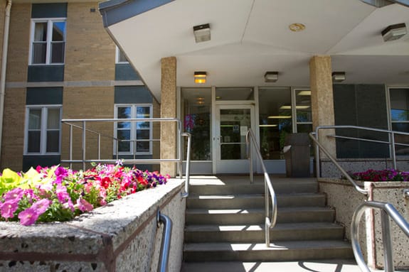 Entrance with flowers and accessible ramp at the facility