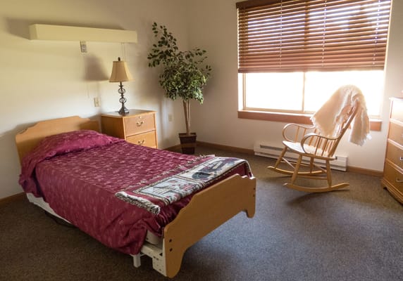 Cozy resident room with bed and rocking chair