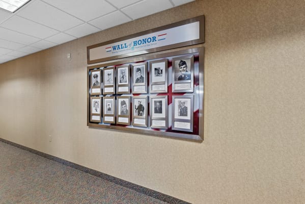 Interior photo of the Wall of Honor displaying framed portraits