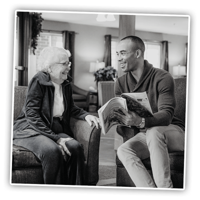 Resident and staff member enjoying conversation in a common area