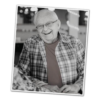Smiling senior resident in a lively common area