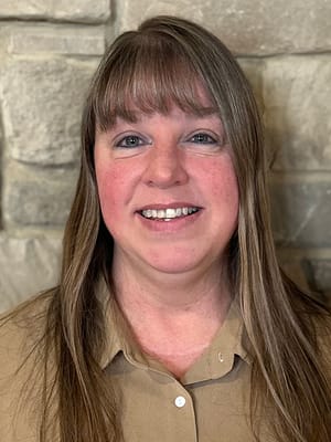 Staff member smiling in a friendly environment