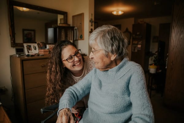 A caregiver and resident sharing a moment indoors