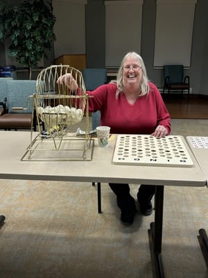 Resident playing bingo in an activity room