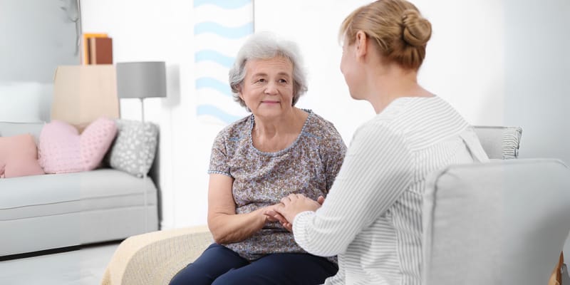 Caregiver and resident interacting in a cozy room
