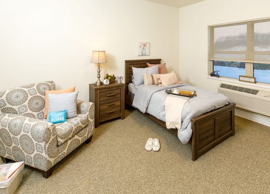 Cozy resident room with a bed and seating area