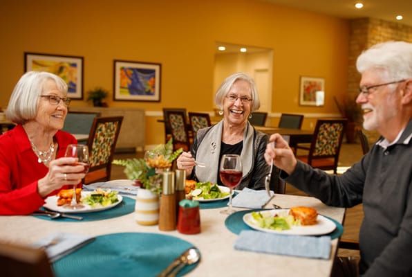 Residents enjoying a meal together in a dining area.