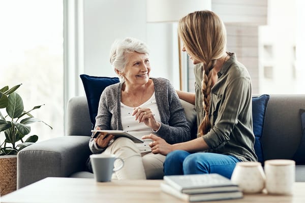 Senior resident enjoying conversation with a staff member