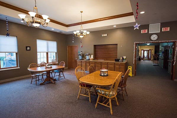 A cozy dining room with wooden tables and chairs