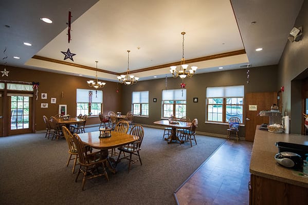 Bright common area with dining tables and chairs