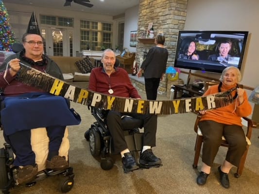 Residents celebrating New Year's Eve in a festive common area
