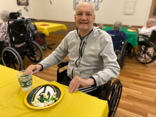 Resident enjoying a snack at a common area table